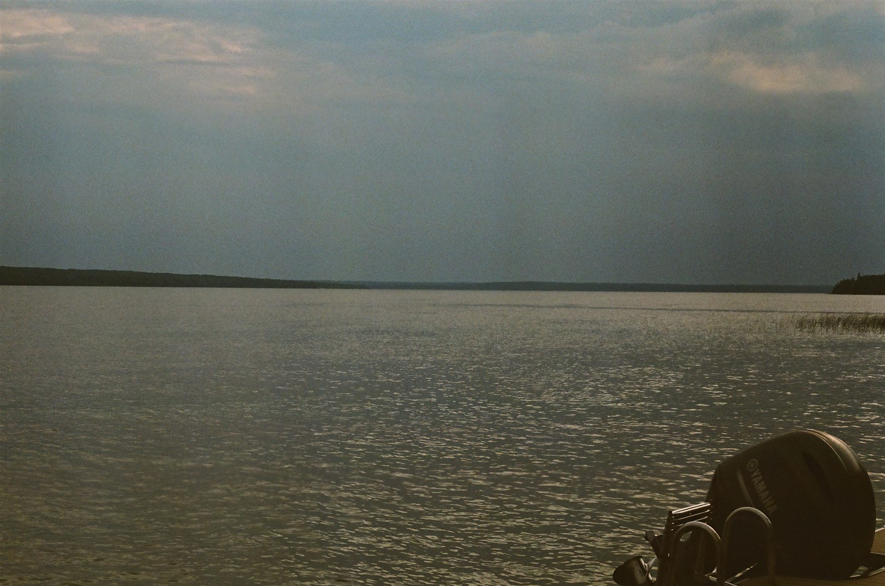 A calm lake under a grey sky