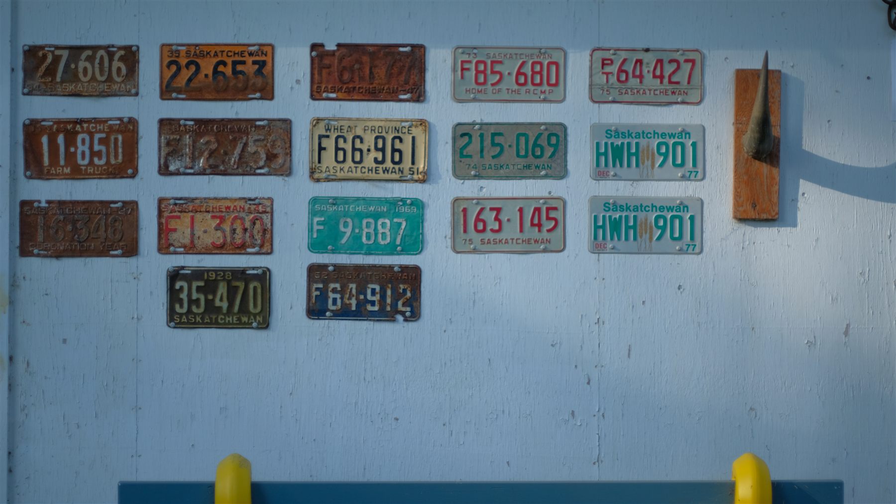 Old licence plates mounted on a wall