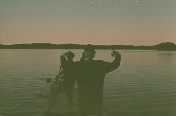 Silhouettes standing in a lake at dusk