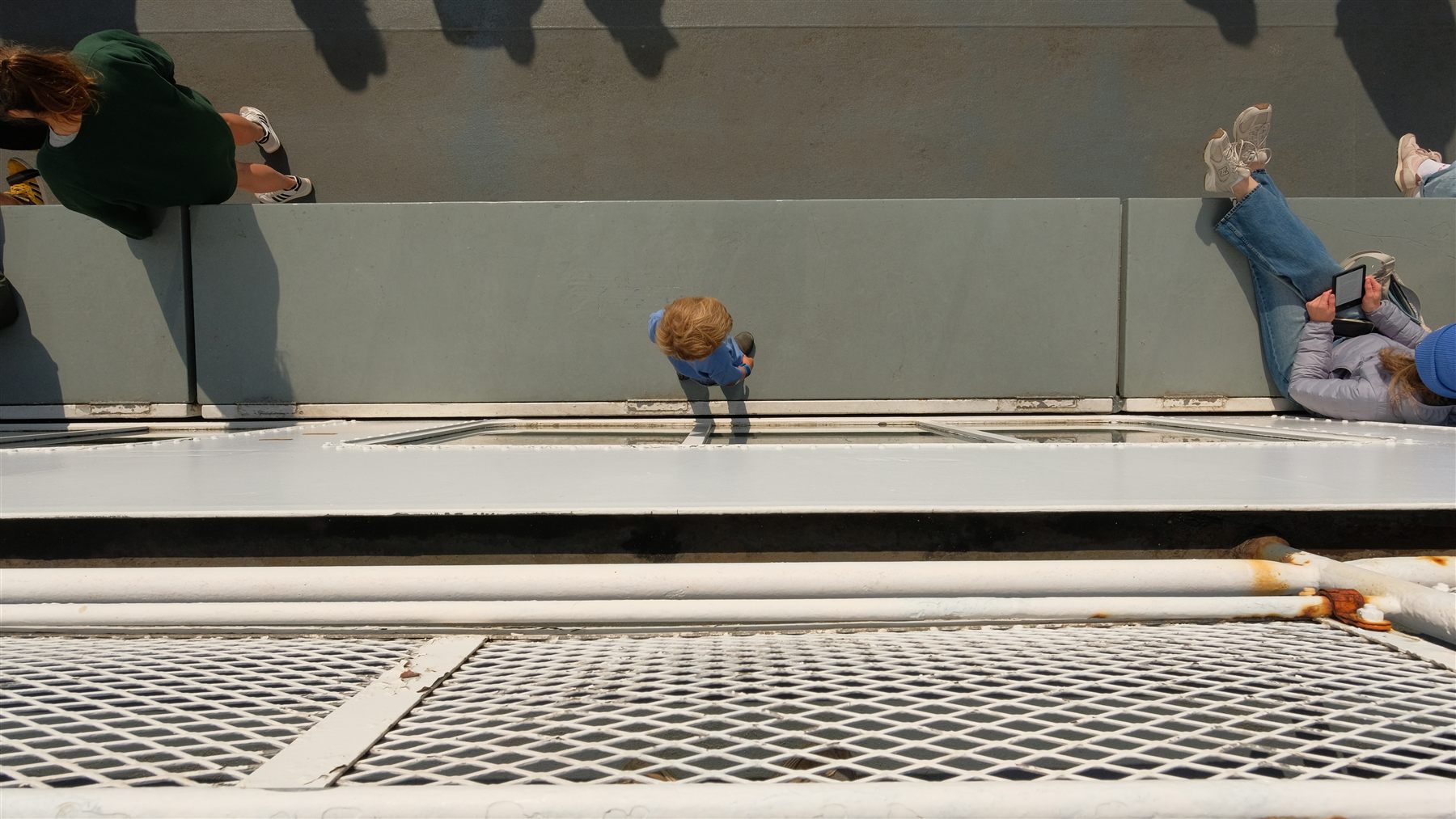 A boy looking out from the ferry railing