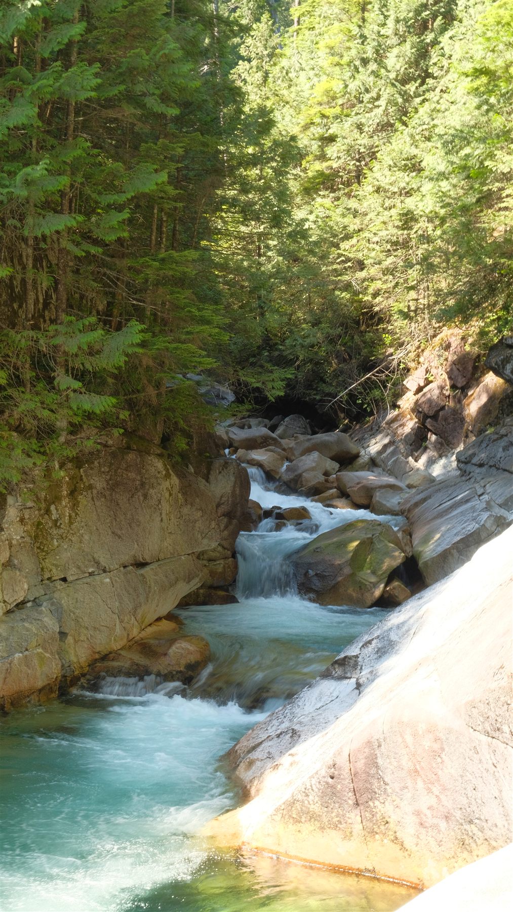 Turquoise water rushing through a rocky canyon
